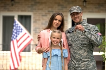 Soldier holding keys with a woman and a child 