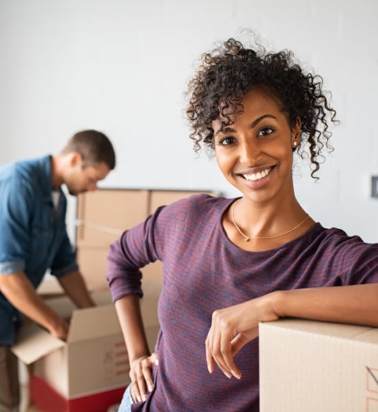 Man and woman unpacking moving boxes