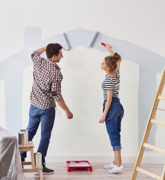 Man and woman painting walls