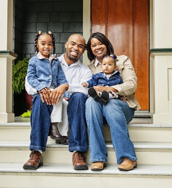 Family sitting on steps of porch