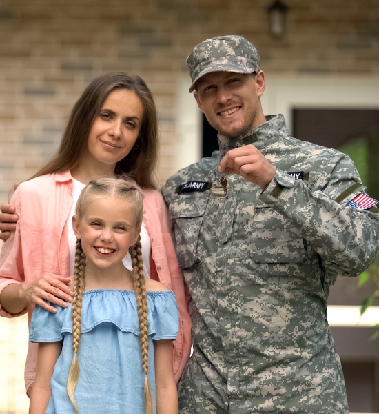 Soldier holding keys with a woman and child