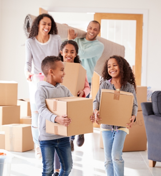 Family happily moving boxes