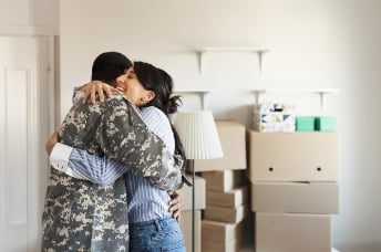 Soldier and woman embracing 