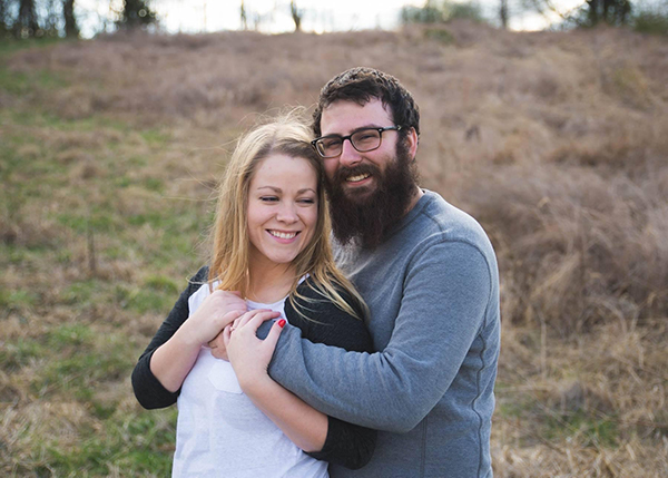 Craig Park and wife, Avery posing outside