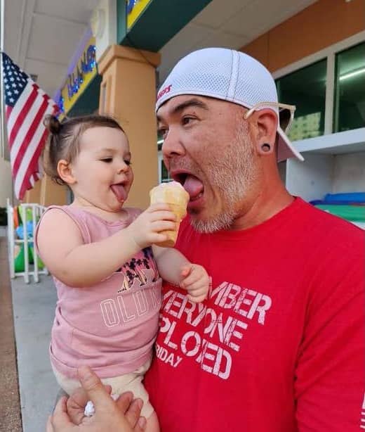 Glenn eating ice cream with young daughter