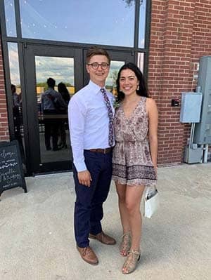 Heath Snider standing in front of building with female partner