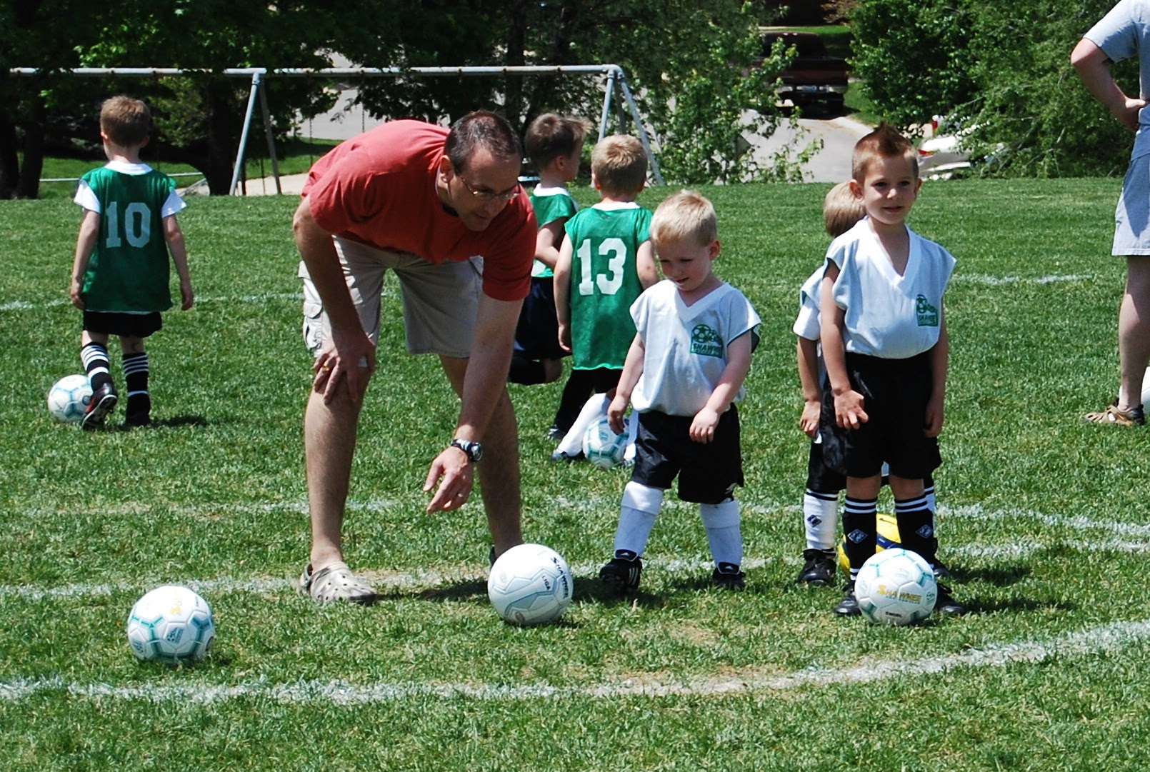 John practicing soccer with kids