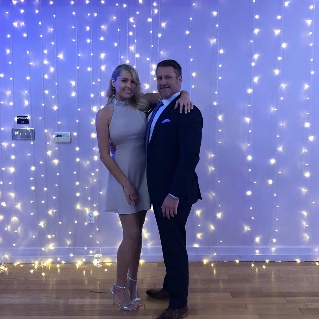 Kelly and his wife dressed nicely posing for a picture together